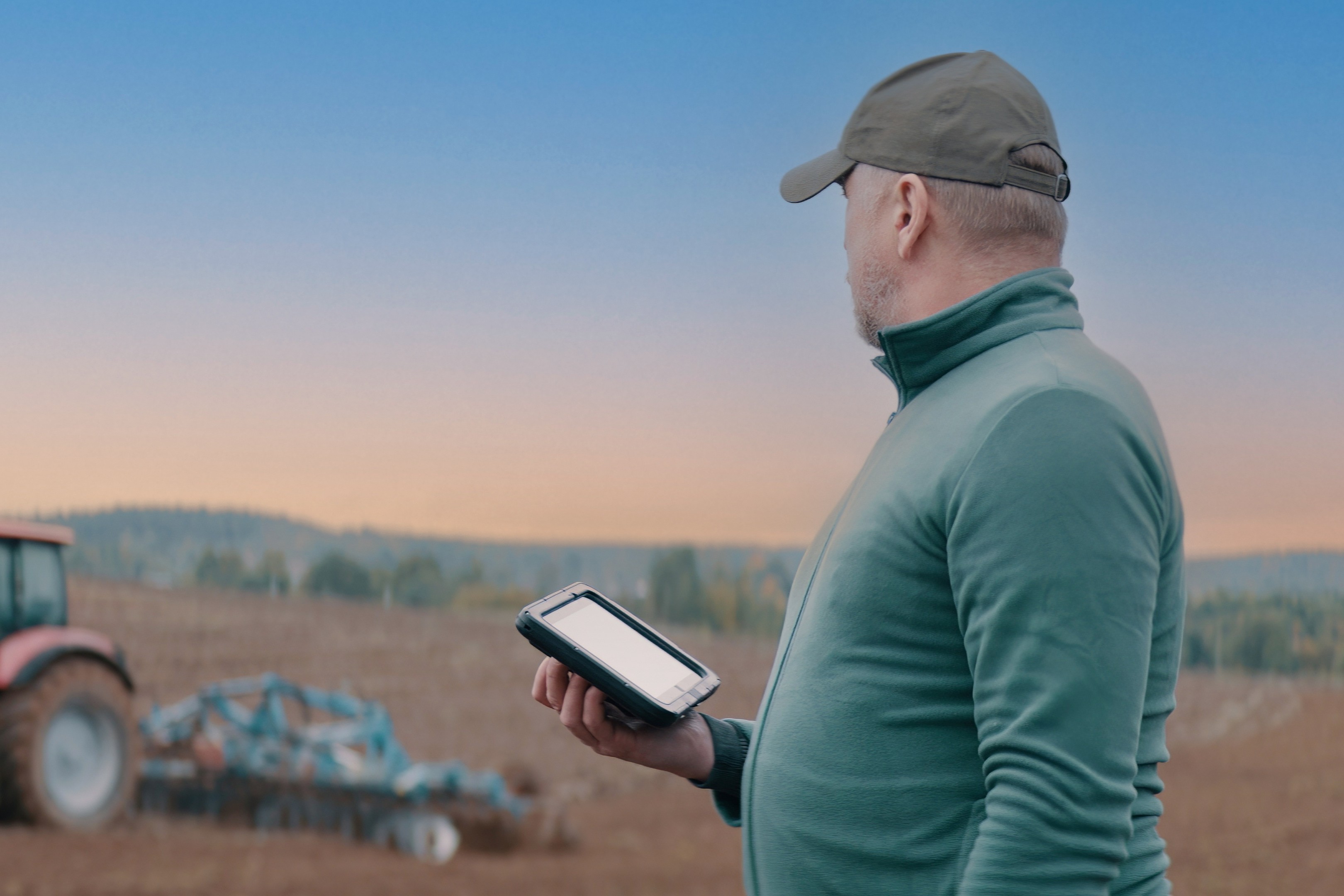 farmer with a tractor using a tablet
